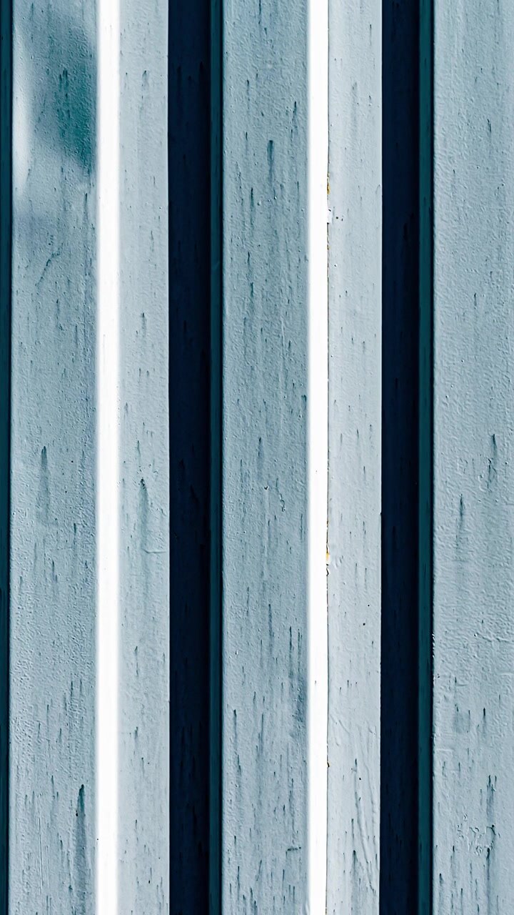 Weathered vertical metal corrugated surface
