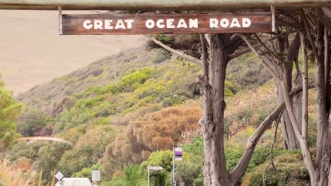 car driving under great ocean road sign