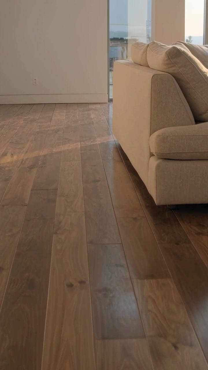 Vertical video: Camera starting panning slowly along floor to reveal beige sofa, copy space