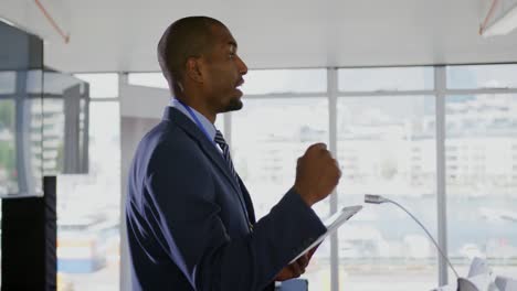 Male speaker addressing the audience at a business conference