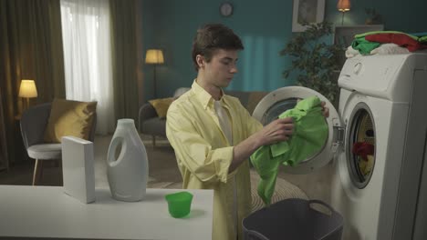young man doing laundry