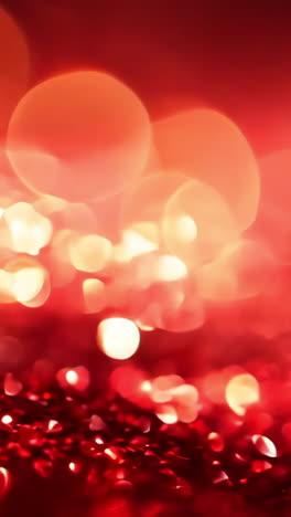 a red background with a lot of sparkles. the sparkles are red and they are scattered all over the background