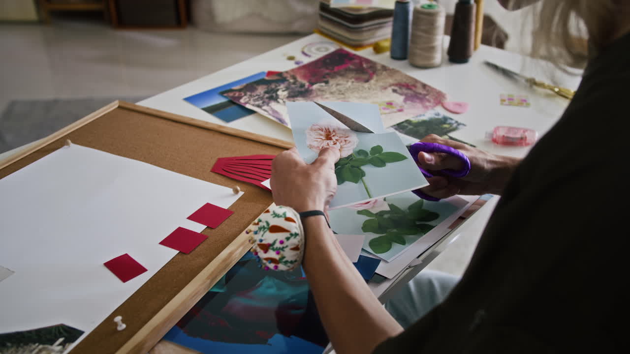 Designer Cutting Photos for Making Collage at Atelier