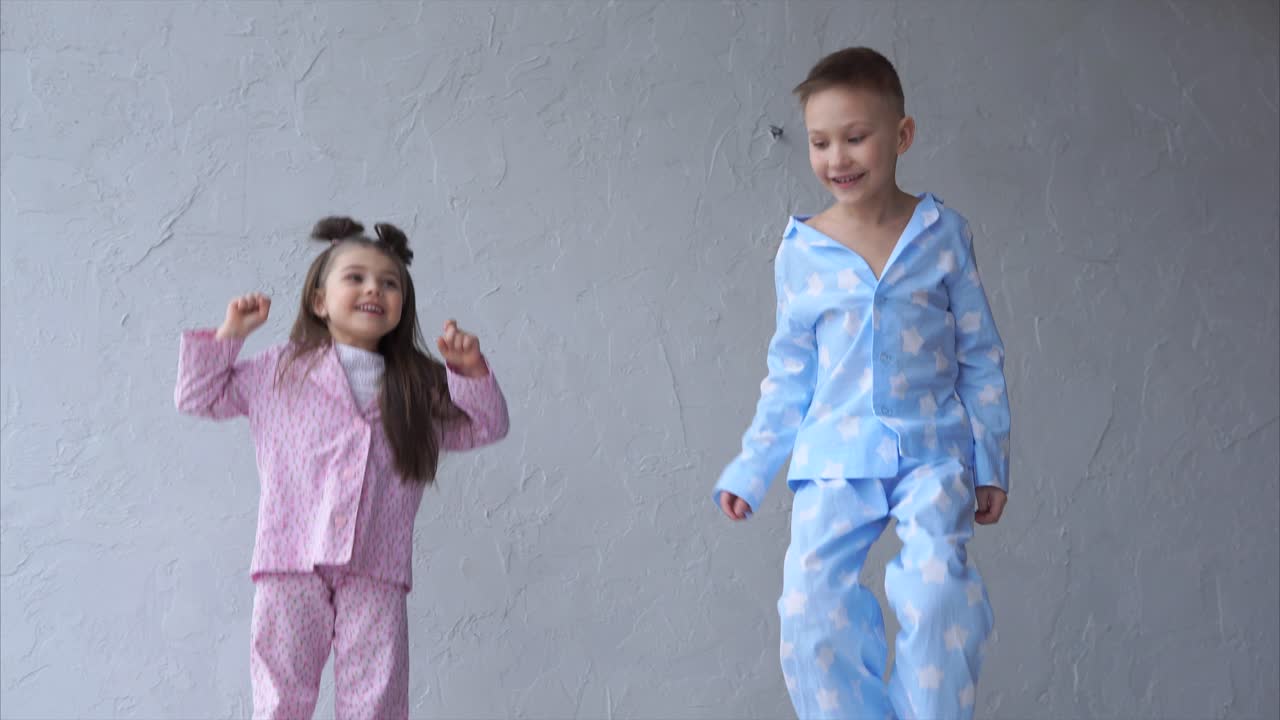 Happy Siblings in Pajamas Jumping