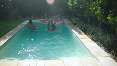 diverse friends enjoying sunny day swimming and relaxing with inflatable in backyard pool