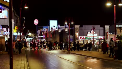 new year at niagara, street filed with people at night, casino ally with people in winter, led lights, bright lights, street filled with people niagara falls canada