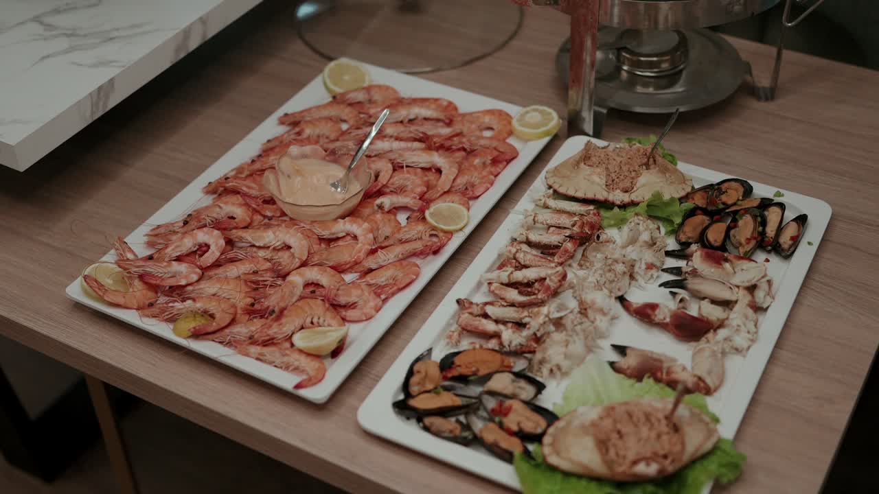 Close view of seafood buffet plates with prawns mussels crab and lemon