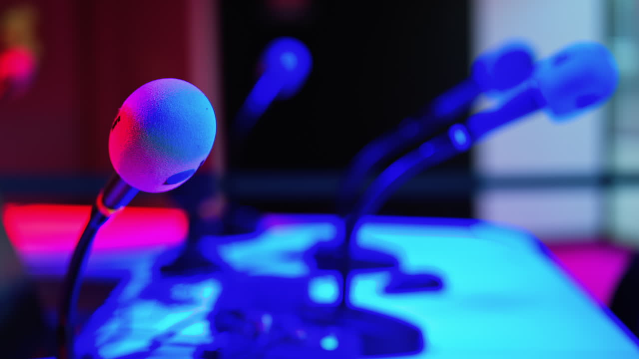 Close up of a microphone on a blurred background with blue and red lights at the International Games Festival in Cannes, France