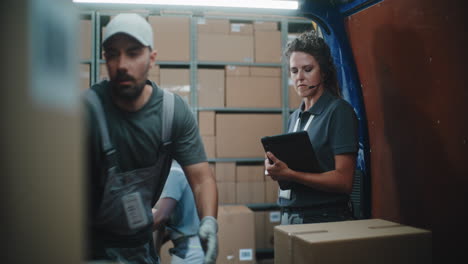 logistics team efficiently loading and scanning packages in a delivery truck