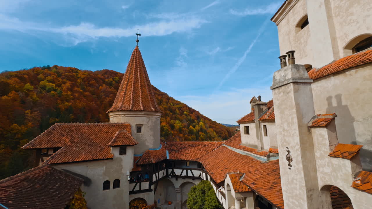 Bright tiled rooftops of the castle Bran in Brasov, Transylvania, Romania. Beautiful view of medieval building in autumn.
