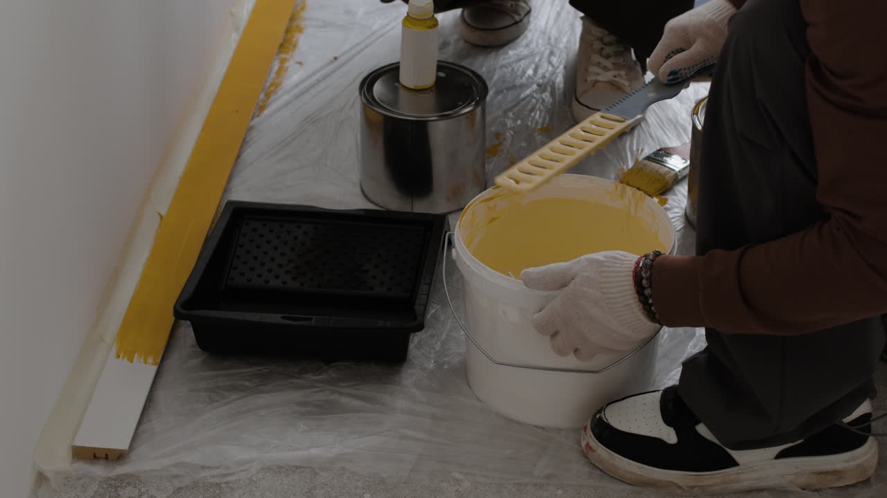 Person Painting a Wall Yellow