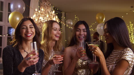 female friends make toast as they celebrate at party