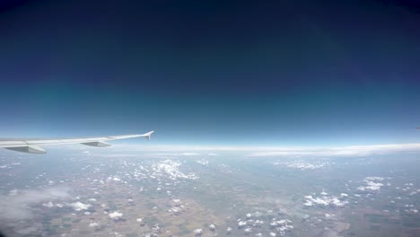 a short video out of the window of a passenger jet crossing the midwest of the us