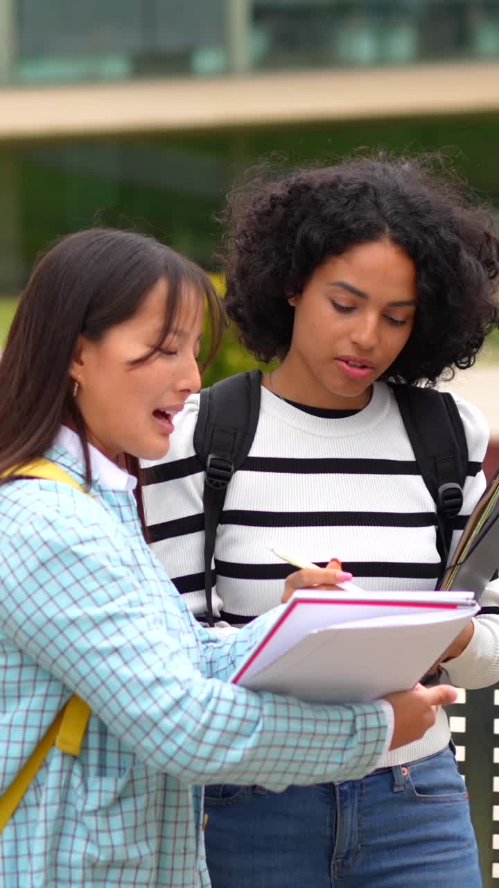Two female students studying together on campus