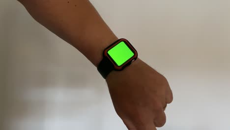 sportive and athlete man using her green screen smart watch and touch him