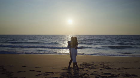 couple in love on beach at sunset