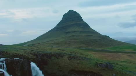 An-aerial,-cinematic,-4K-drone,-a-unique-top-view-of-the-Kirkjufell-peak-surrounded-by-the-landscape-below-it