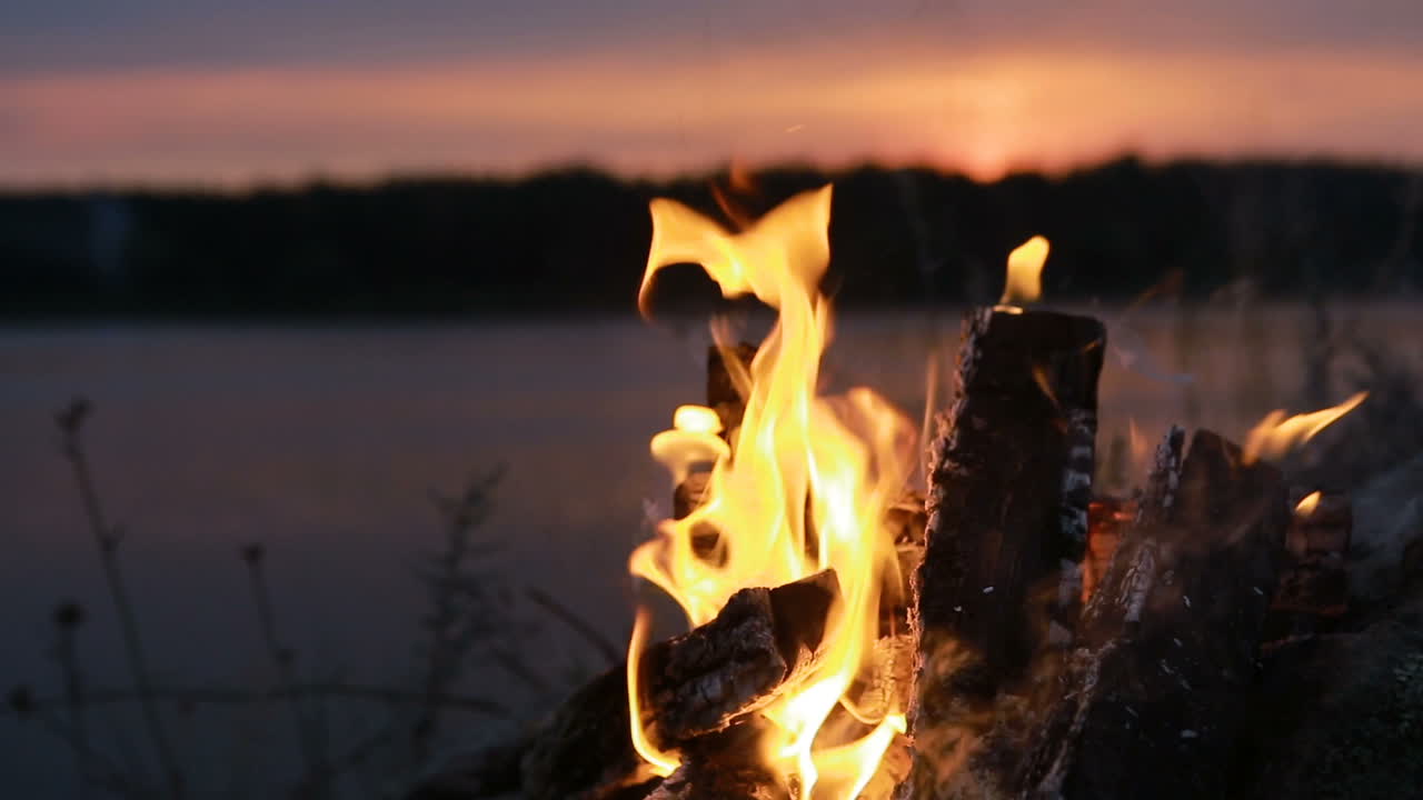 Big Night Bonfire On The Riverbank. Red hot flame of campfire in the evening