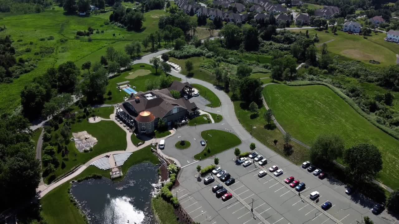 Aerial Drone rotating view of a banquet house for celebrations and weddings, surrounded by green land and trees