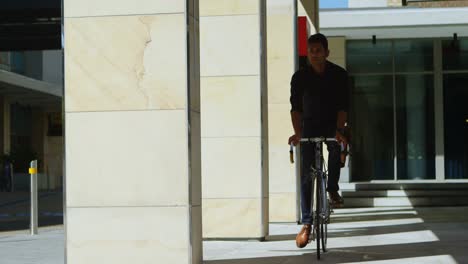 Man-checking-time-on-smartwatch-while-riding-bicycle-4k