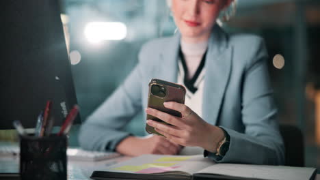 businesswoman using smartphone at desk