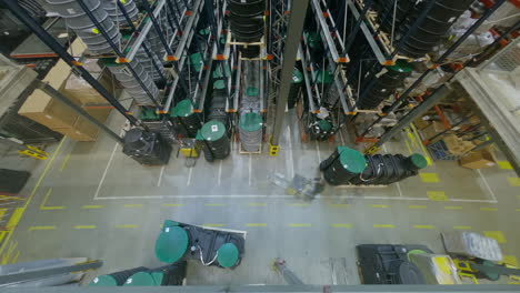 timelapse top-down shot of an industrial hall, forklift truck operator drive with plastic cast in a big retail warehouse, logistics product and goods delivery and distribution center