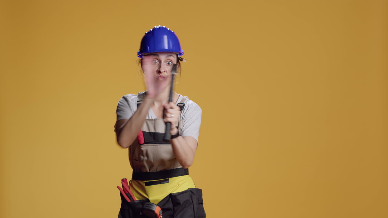 Portrait of aggressive constructor threating with hammer