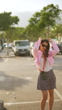 young woman in a pink shirt and floral skirt