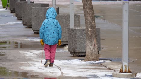 child walking along snowy path