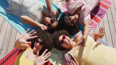 Portrait-of-happy-diverse-female-friends-smiling-at-swimming-pool-party