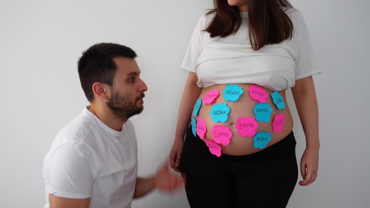 Man expectant for his future baby with name options in his wife's belly