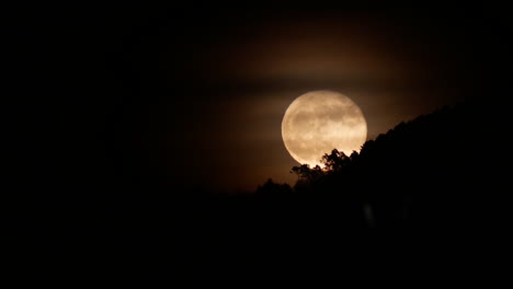 2017 july rising full moon on the countryside of tuscany, italy.
