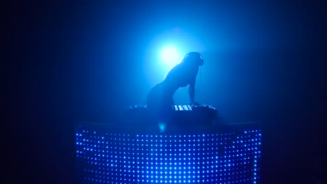 dj woman silhouette in blue light