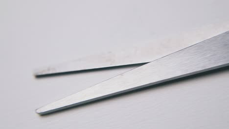 scissors with black plastic handles lie on white background