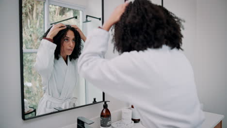 woman getting ready in the bathroom mirror