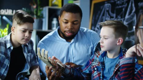 children studying robotic technology in class