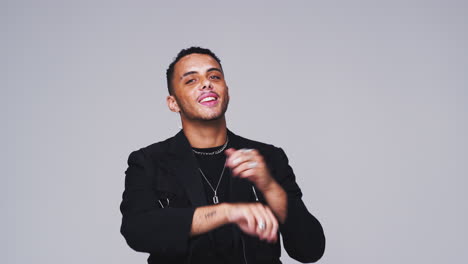 Wide-Angle-Studio-Shot-Of-Young-Man-Against-White-Background-Dancing-In-Slow-Motion