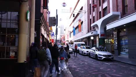 pedestrians walking along a bustling city street