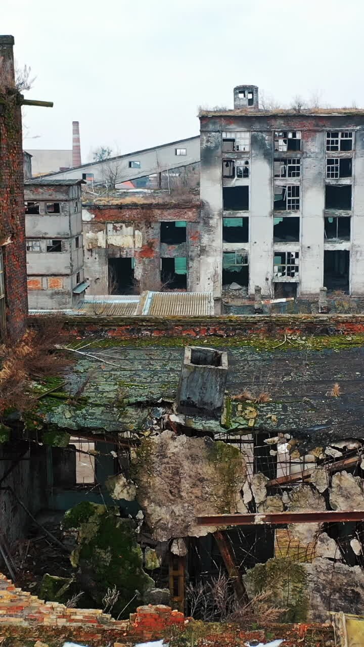 Abandoned industrial building. Ruins of an old factory. Aerial view Vertical video
