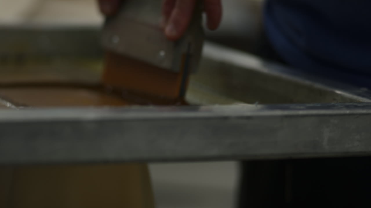 Premium stock video - Ink being applied during screen printing process