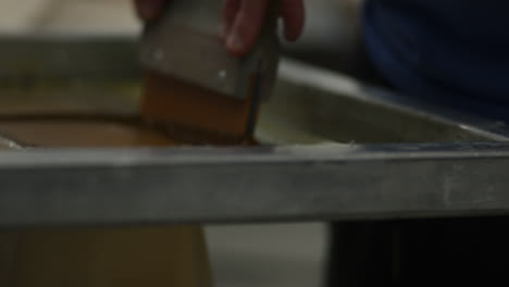 ink being applied during screen printing process