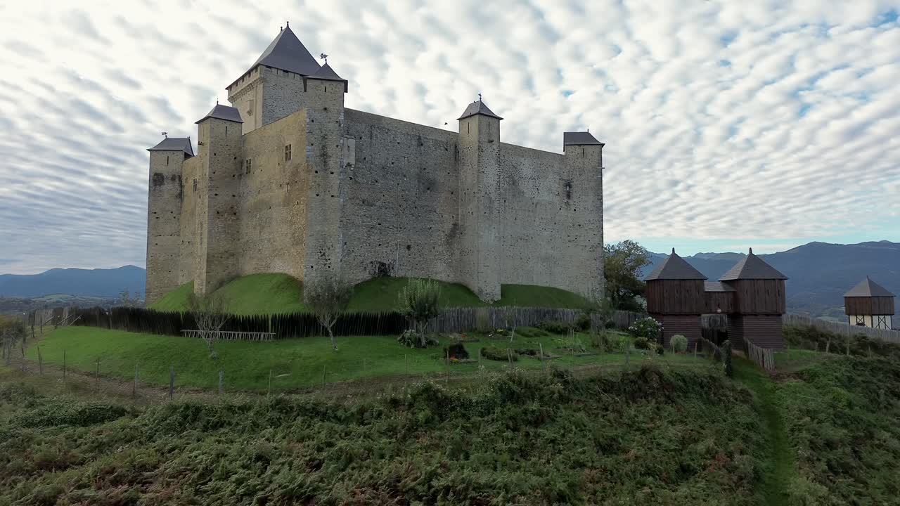 Aerial view on Mauvezin castle, a fortress with a medieval military architecture located in Occitania, France (dolly forward)