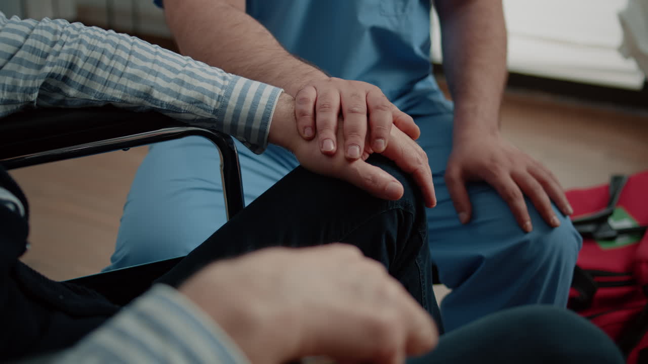 Close up of hands of nurse and senior patient at medical visit