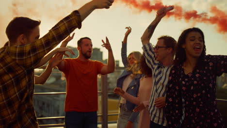 Happy-friends-hanging-out-with-smoke-bombs.-Beautiful-people-having-fun-at-party