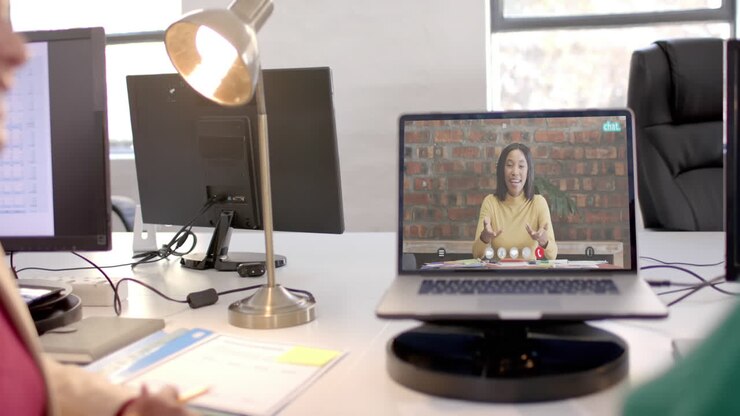 Laptop with video call with caucasian businesswoman on screen