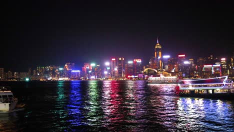 boats and city lights reflecting on water