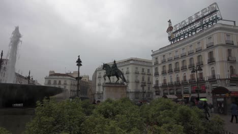 puerta del sol with fountain and statue of carlos iii