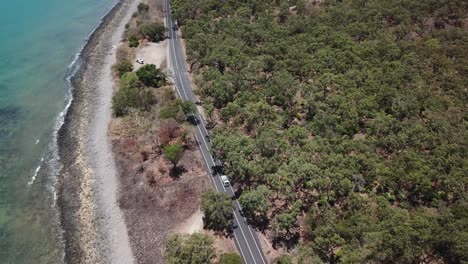 Drone-pan-up-to-reveal-mountainside-next-to-beach