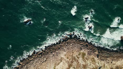 aerial view of rocky coastline with waves