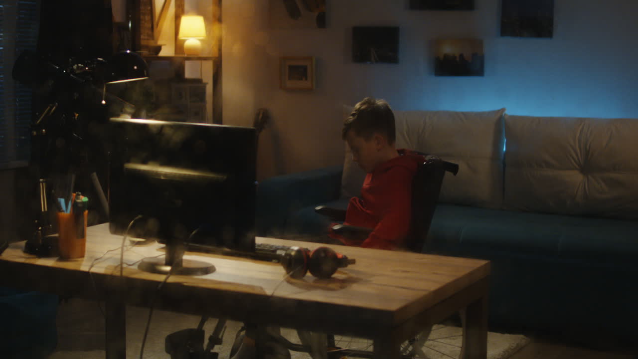 Boy gaming in his bedroom at night